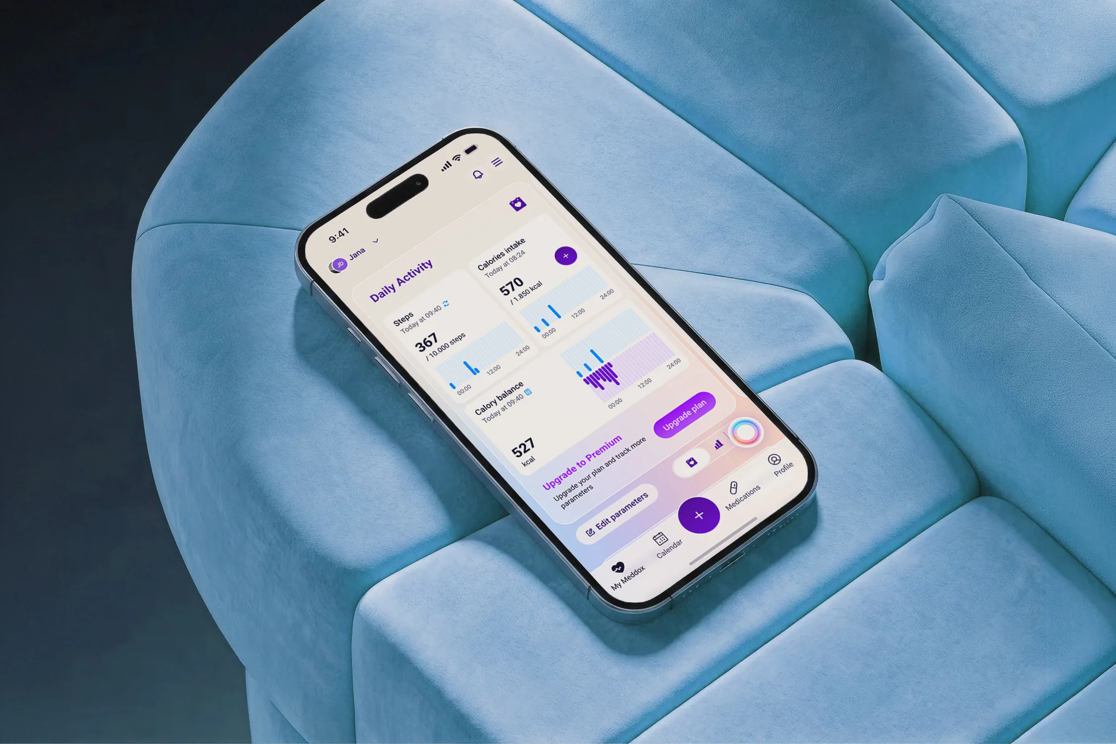An iPhone resting on a blue velvet chair shows the Meddox app's Daily Activity dashboard tracking steps, calories, and calory balance.